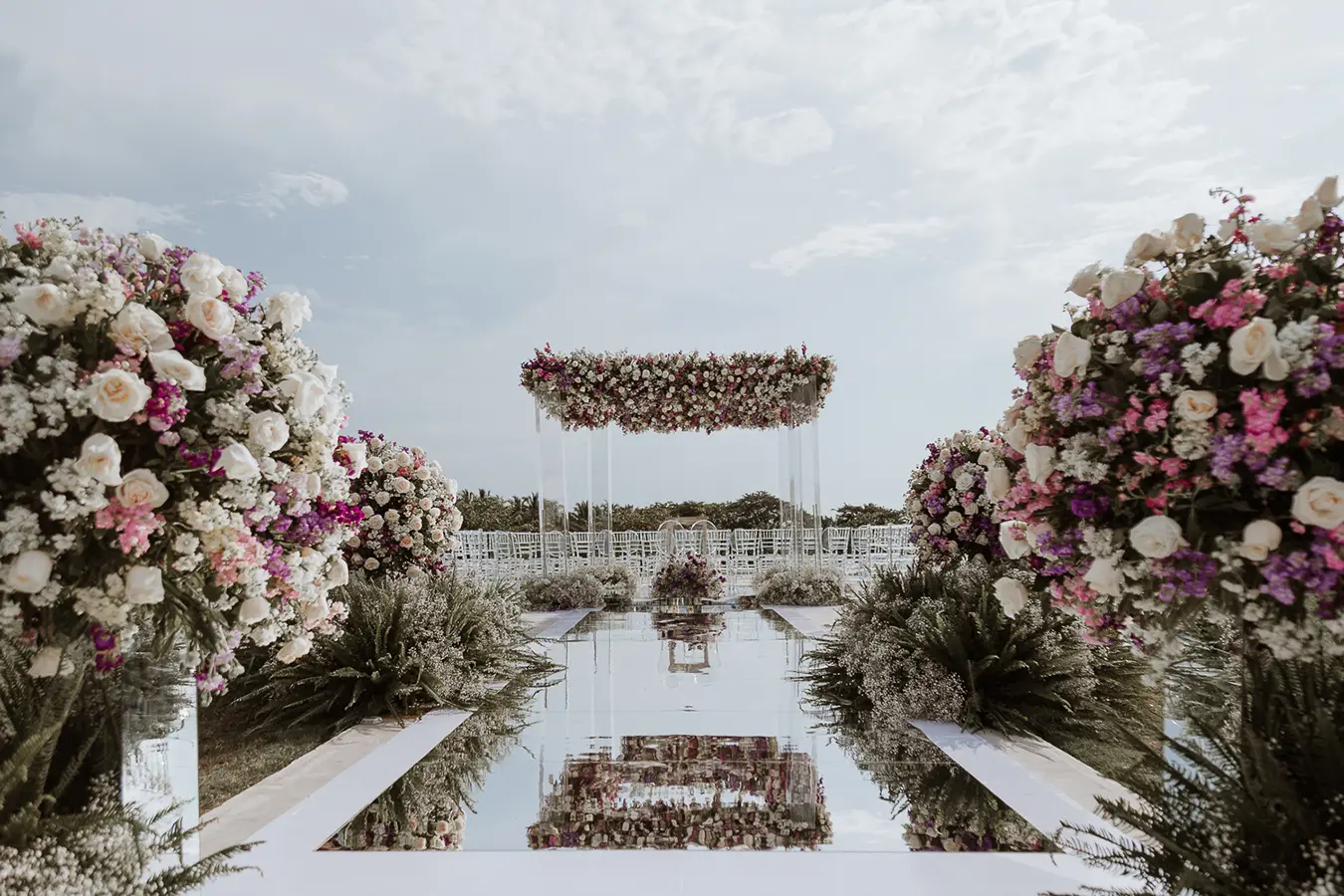 Ceremony altar framed by arches of pink and white flowers