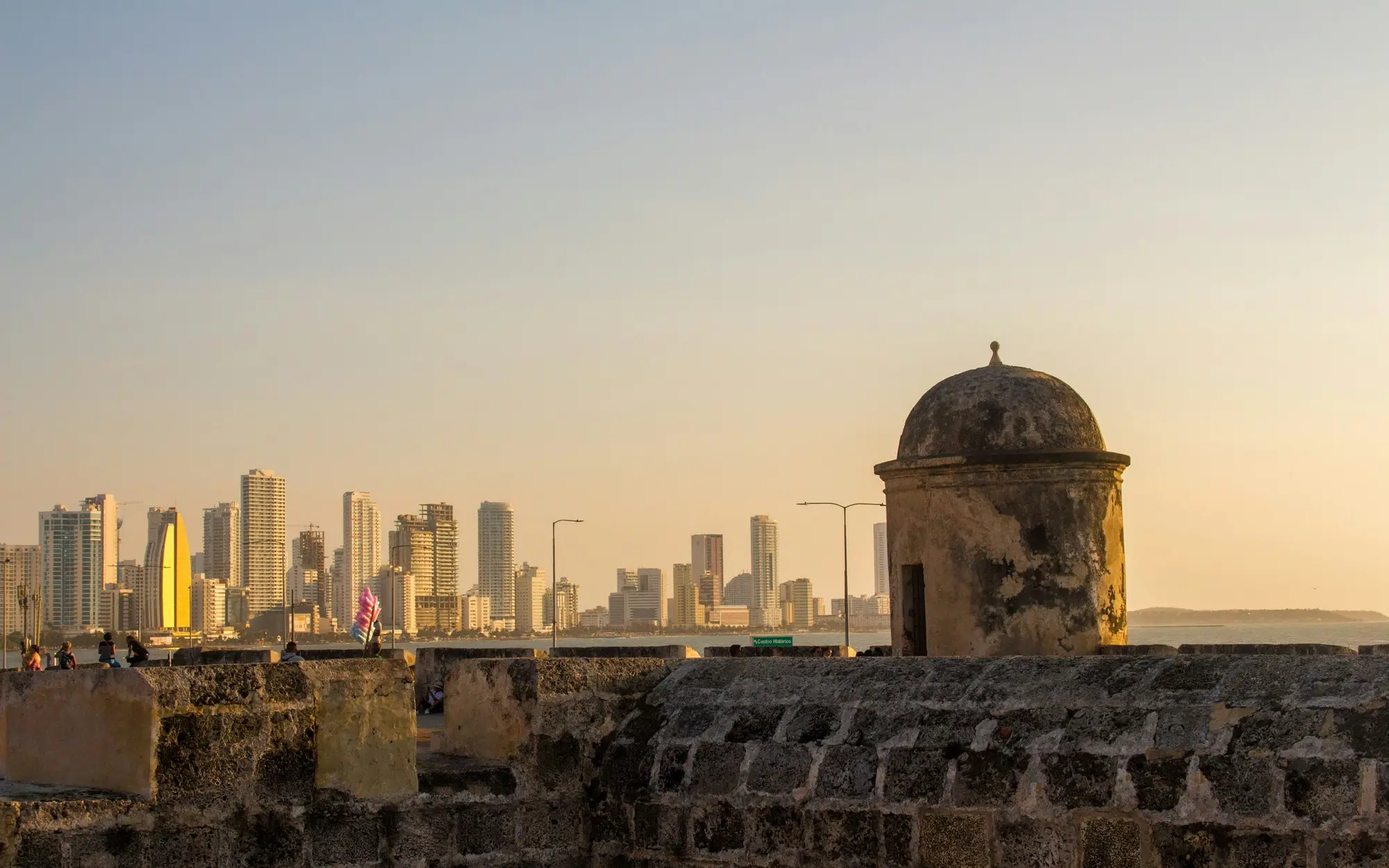 The Cartagena city wall at sunset, with the sea and the skyline of Bocagrande