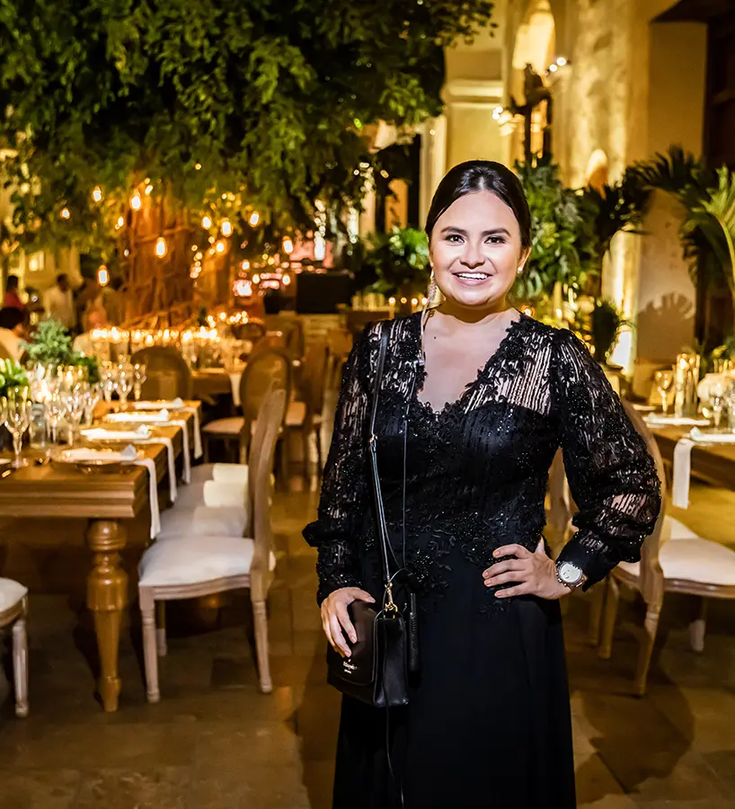 Sonia Martínez standing in a reception hall set for a wedding